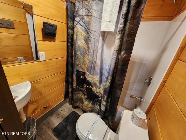 1012 Ravens Ford Way, Sevierville, TN 37876 - full bathroom with toilet, wood walls, a shower with curtain, and wood finished floors