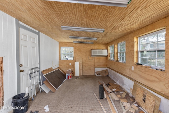 interior space with wood ceiling and an AC wall unit