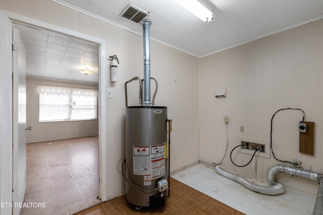 utility room featuring water heater and visible vents