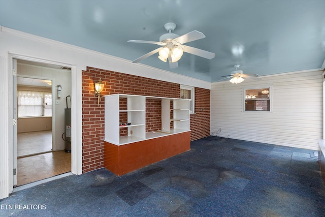 interior space with brick wall, ornamental molding, carpet floors, and gas water heater