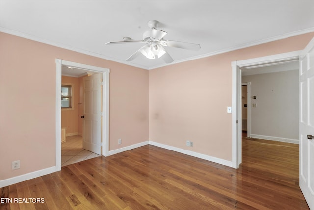 unfurnished bedroom with baseboards, ornamental molding, and wood finished floors