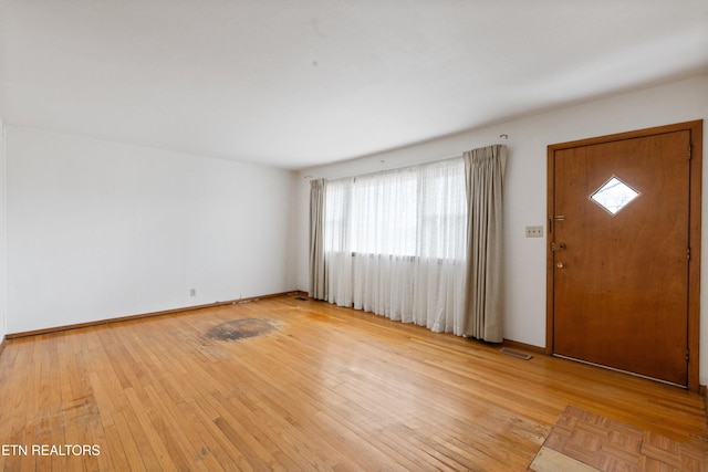 entrance foyer featuring light wood-type flooring, baseboards, and visible vents