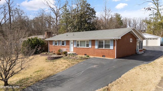 ranch-style house with brick siding, a chimney, crawl space, a garage, and an outdoor structure