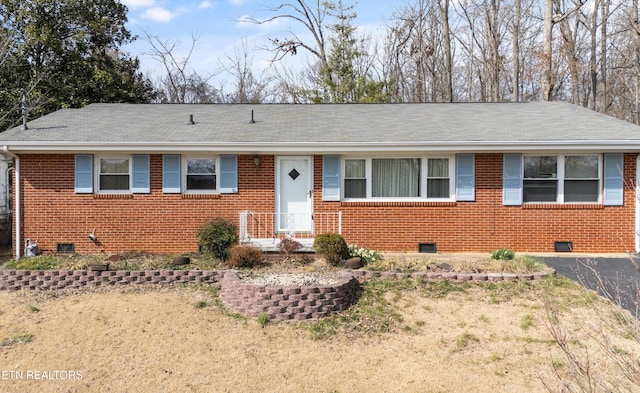 ranch-style home with roof with shingles, brick siding, and crawl space