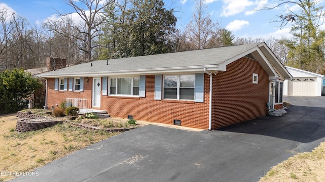 single story home featuring an outbuilding, brick siding, crawl space, and a detached garage