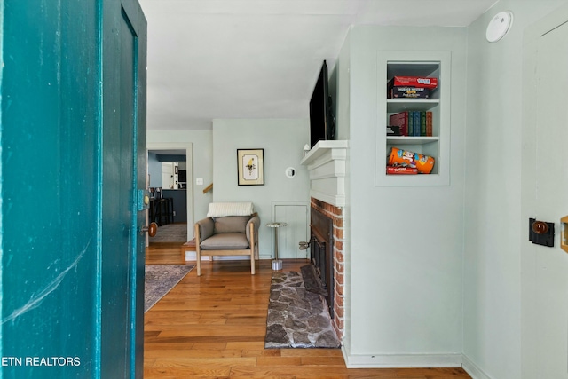 corridor with wood finished floors and built in features