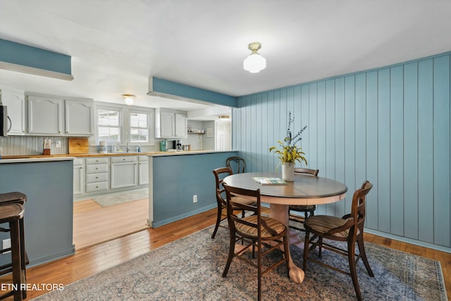 dining space featuring light wood-style flooring