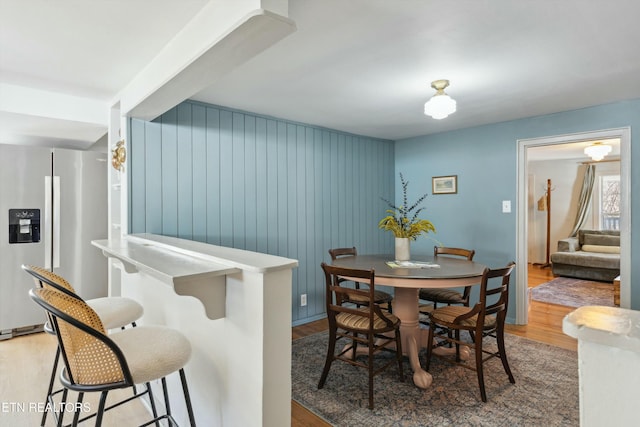 dining space featuring light wood-style flooring and stairway