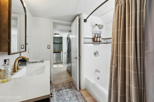 bathroom with shower / bath combo, wood finished floors, and vanity