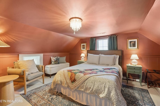 bedroom with lofted ceiling and an inviting chandelier