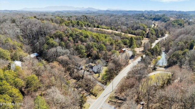 drone / aerial view with a forest view and a mountain view