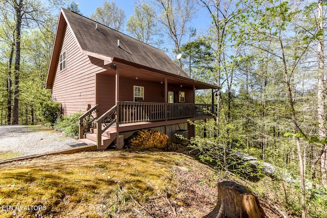 rustic home with stairs and a wooden deck