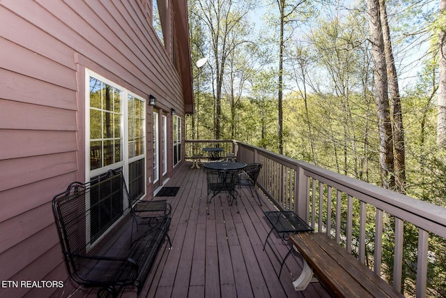 wooden terrace with outdoor dining space