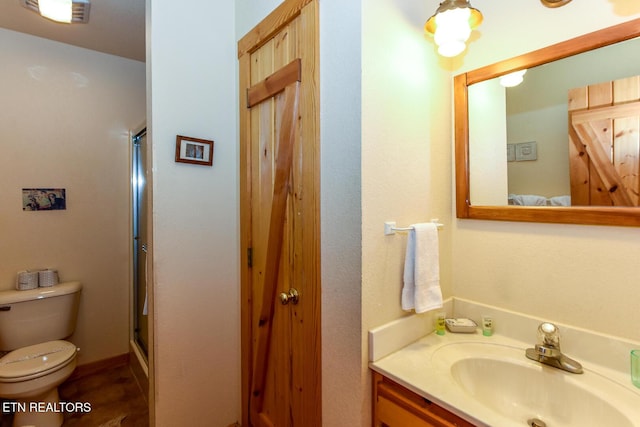 full bath featuring visible vents, vanity, a shower with door, and toilet