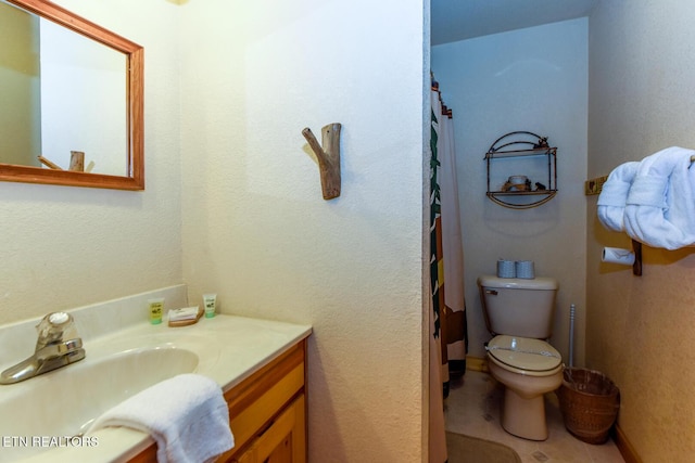 bathroom with toilet and vanity