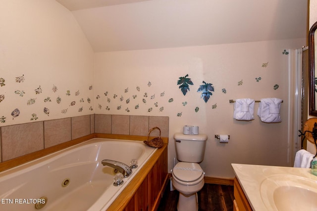 bathroom with lofted ceiling, toilet, vanity, a tub with jets, and wallpapered walls