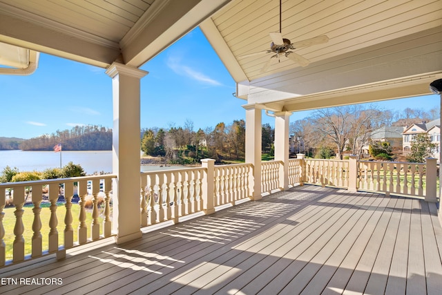 wooden deck with a ceiling fan and a water view