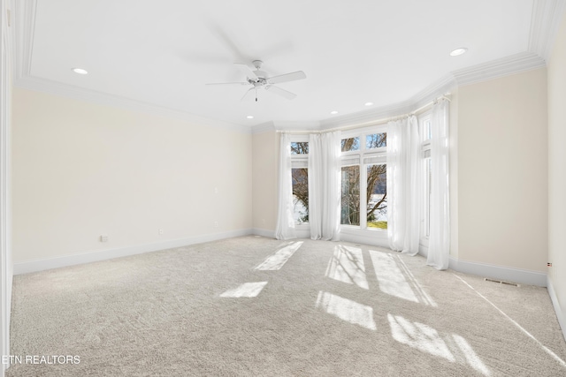 spare room with ornamental molding, carpet flooring, visible vents, and baseboards