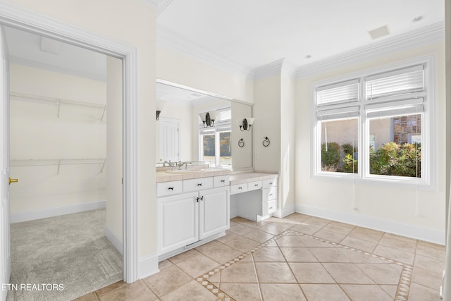 full bathroom with vanity, baseboards, a spacious closet, ornamental molding, and tile patterned floors