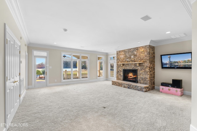 unfurnished living room featuring crown molding, visible vents, carpet flooring, a stone fireplace, and baseboards