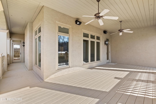 wooden deck featuring a ceiling fan