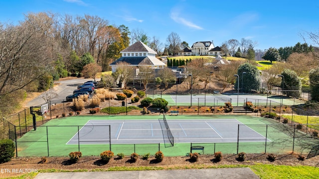 view of tennis court with fence