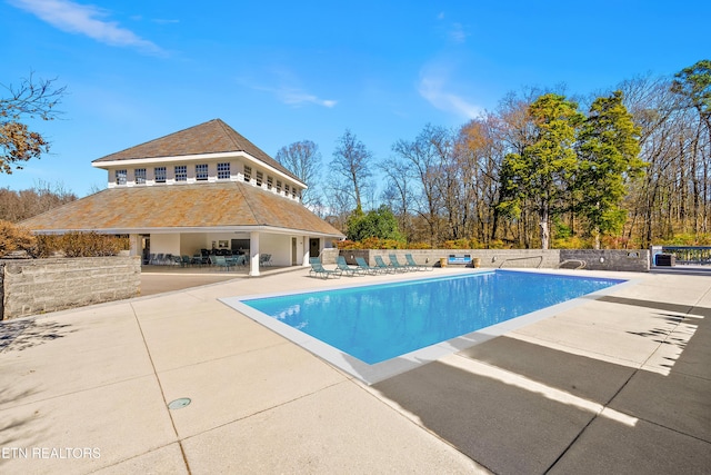 view of swimming pool featuring fence, a fenced in pool, and a patio