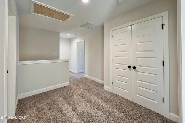 carpeted spare room with visible vents, recessed lighting, attic access, and baseboards