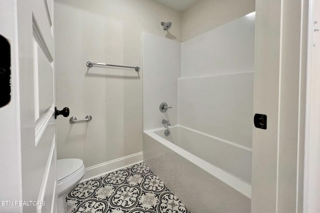 full bathroom with bathing tub / shower combination, tile patterned flooring, toilet, and baseboards