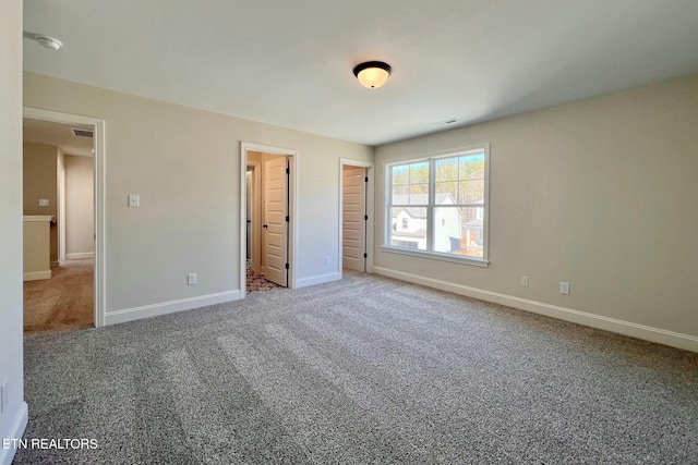 unfurnished bedroom featuring carpet floors and baseboards