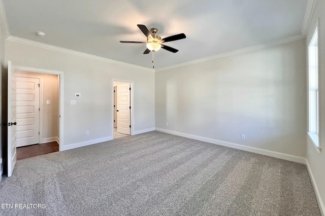 unfurnished bedroom featuring carpet, baseboards, a ceiling fan, and ornamental molding