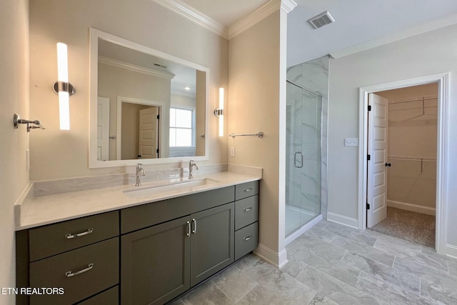 full bath featuring visible vents, ornamental molding, a walk in closet, vanity, and a shower stall