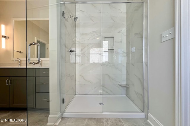 bathroom with a shower stall and vanity