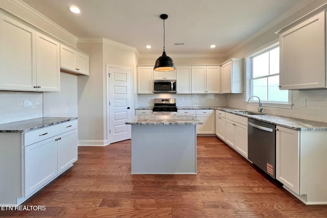 kitchen featuring light stone countertops, stainless steel appliances, and a sink