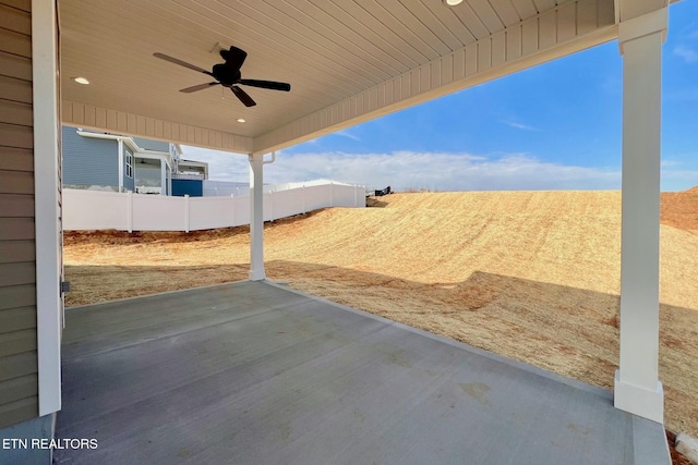 view of patio featuring ceiling fan and fence