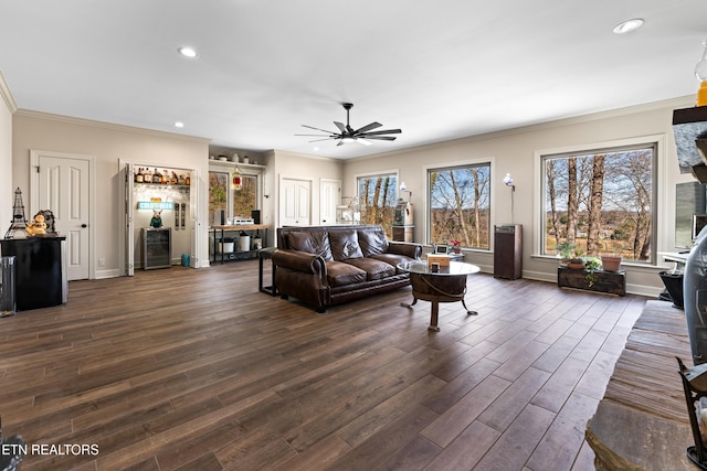 living area featuring ornamental molding, a ceiling fan, recessed lighting, baseboards, and dark wood-style flooring