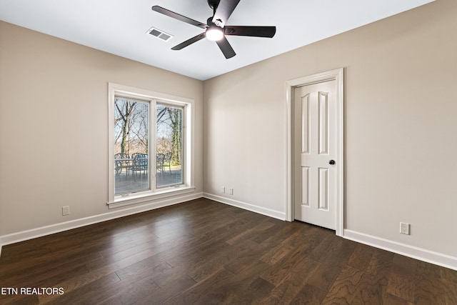 unfurnished bedroom with visible vents, dark wood-type flooring, and baseboards