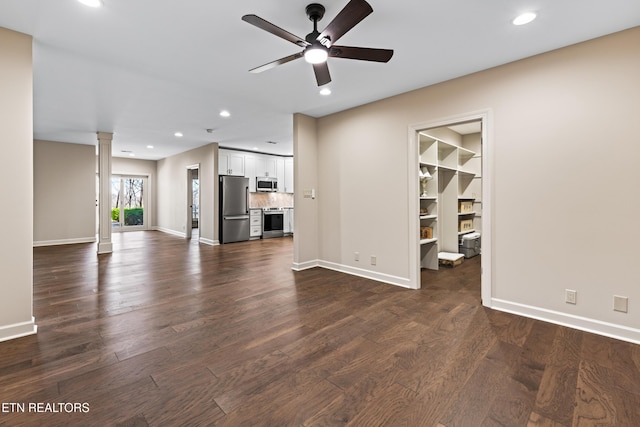 unfurnished living room with recessed lighting, baseboards, ceiling fan, dark wood-style flooring, and ornate columns