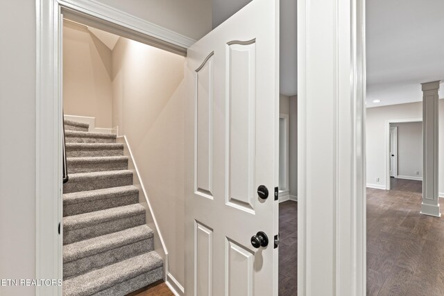 stairs featuring ornate columns, recessed lighting, baseboards, and wood finished floors