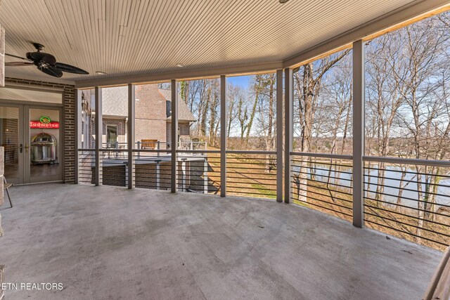 unfurnished sunroom featuring ceiling fan