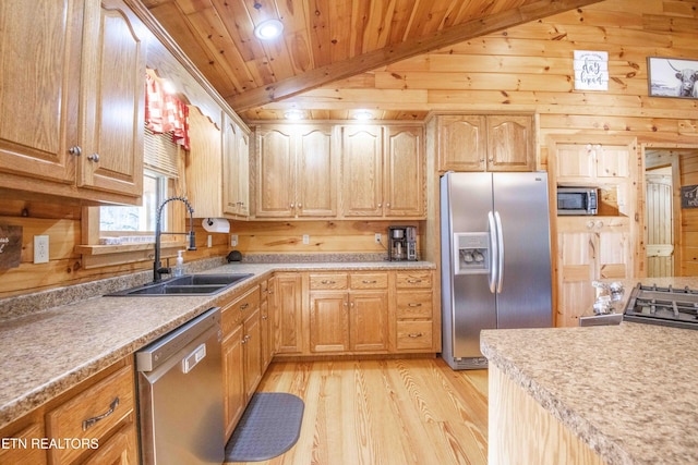 kitchen featuring lofted ceiling, appliances with stainless steel finishes, a sink, and wood ceiling