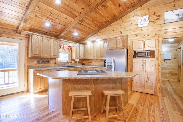 kitchen featuring stainless steel appliances, light wood-type flooring, wooden ceiling, and a center island