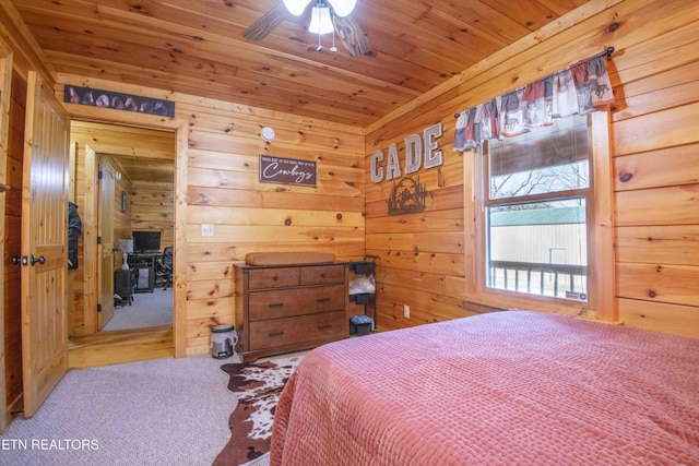 bedroom with carpet, wooden ceiling, and wooden walls