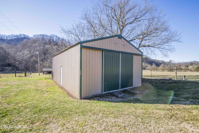 view of pole building with a yard