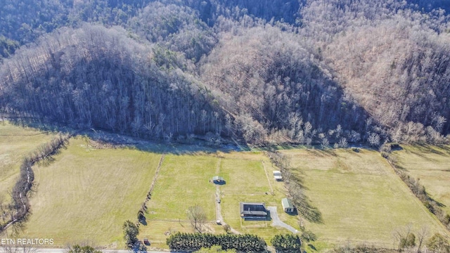 birds eye view of property with a forest view and a rural view