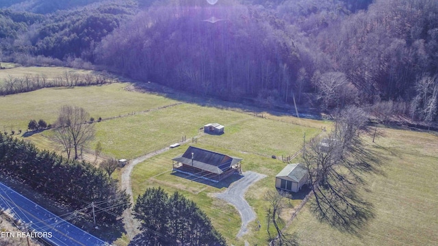 birds eye view of property with a rural view and a forest view