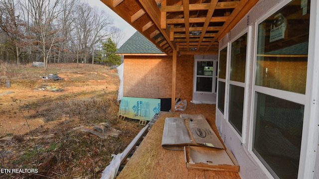 view of property exterior with roof with shingles