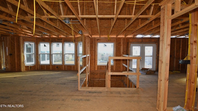 miscellaneous room with french doors, an upstairs landing, and a wealth of natural light