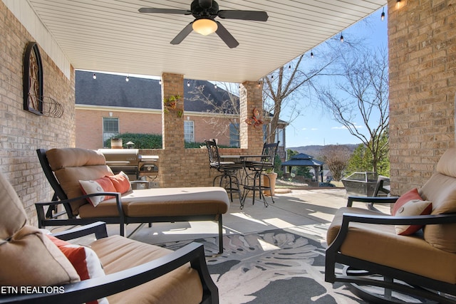 view of patio featuring an outdoor hangout area and a ceiling fan