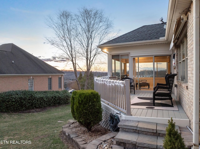 deck at dusk with a lawn